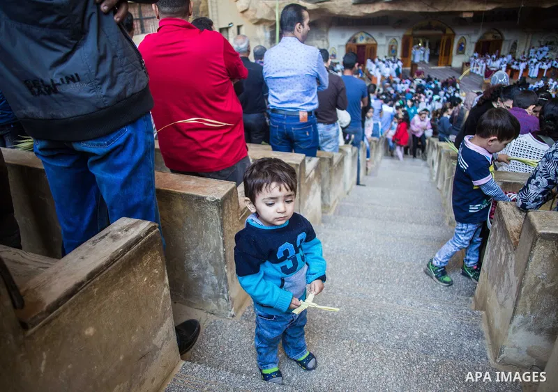 Egyptian Orthodox Christians take part in a mass marking the Palm Sunday at a church in Saint Samaan the tanner Monastery in Cairo on April 1, 2018. Photo by Stringer