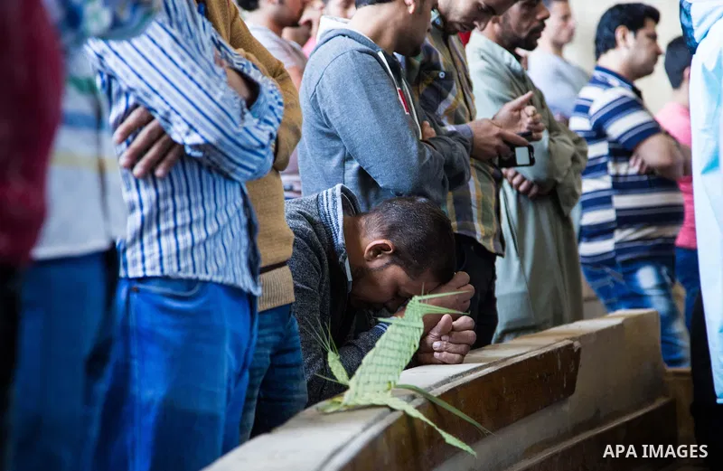 Egyptian Orthodox Christians take part in a mass marking the Palm Sunday at a church in Saint Samaan the tanner Monastery in Cairo on April 1, 2018. Photo by Stringer