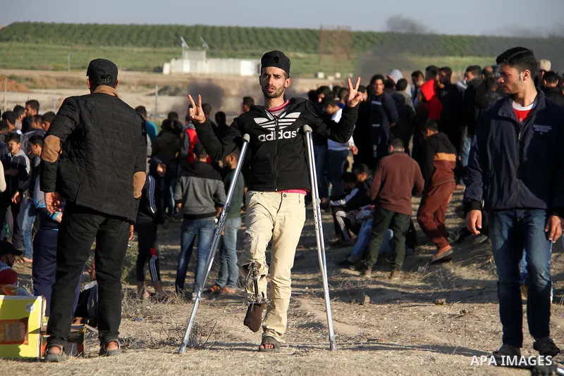 Palestinian protesters demonstrate during clashes with Israeli security forces in a protest, at the Israel-Gaza border, demanding the right to return to their homeland, east of Gaza City April 1, 2018. Photo by Mahmoud A...