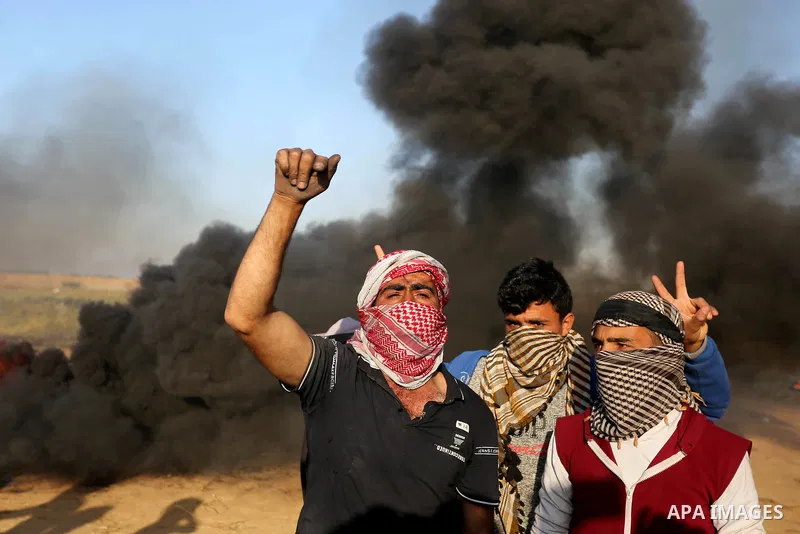 Palestinian protesters demonstrate during clashes with Israeli security forces in a protest, at the Israel-Gaza border, demanding the right to return to their homeland, in Khan Younis in the southern Gaza strip on April...