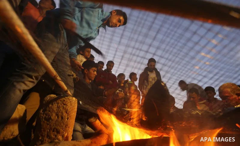 Palestinian protesters prepare dinner during clashes with Israeli security forces in a protest, at the Israel-Gaza border, demanding the right to return to their homeland, in Khan Younis in the southern Gaza strip on Apr...