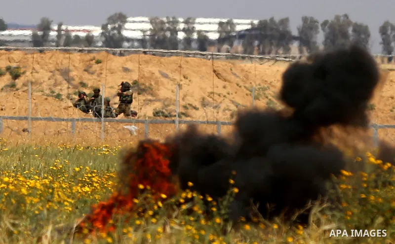 Palestinian protesters demonstrate during clashes with Israeli security forces in a protest, at the Israel-Gaza border during a tent city protest at the Israel-Gaza border, in Khan Yunis in the southern Gaza Strip, on Ap...