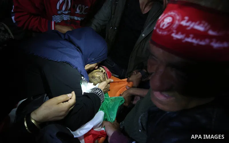 Palestinian women mourn over the body of 25-year-old Ahmed Arafa during his funeral in the city of Deir al-Balah, in the centre of the Gaza Strip on April 4, 2018. Arafa was shot dead by Israeli forces on the Gaza border...