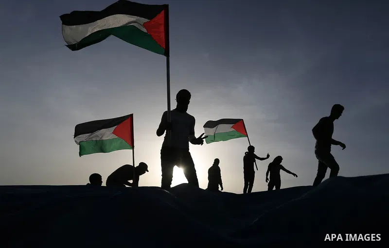 Palestinian protesters take part during a tent city protest, at the Israel-Gaza border, demanding the right to return to their homeland, in Khan Younis in the southern of Gaza strip on April 4, 2018. Photo by Ashraf Amra
