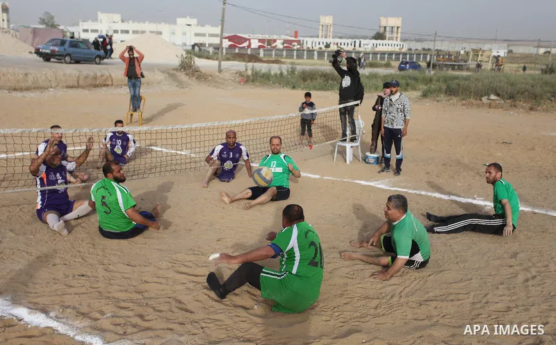 Disabled Palestinians play volleyball near to the site of clashes between Palestinian demonstrators and Israeli security forces following a protest along the Gaza-Israel border, east of Gaza City on April 5, 2018. Palest...