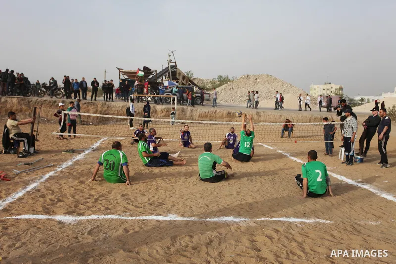Disabled Palestinians play volleyball near to the site of clashes between Palestinian demonstrators and Israeli security forces following a protest along the Gaza-Israel border, east of Gaza City on April 5, 2018. Palest...