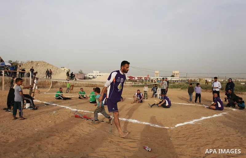 Disabled Palestinians play volleyball near to the site of clashes between Palestinian demonstrators and Israeli security forces following a protest along the Gaza-Israel border, east of Gaza City on April 5, 2018. Palest...