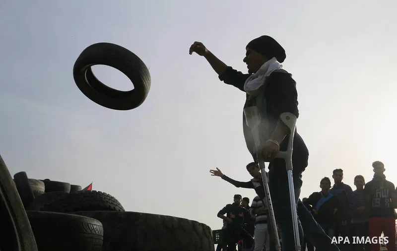 Palestinian protesters bring old tires with pickup trucks as they take part in a demonstration demanding the right of return and removal of the blockade following the "Great March of Return" in Bureij, Gaza on April 05,...