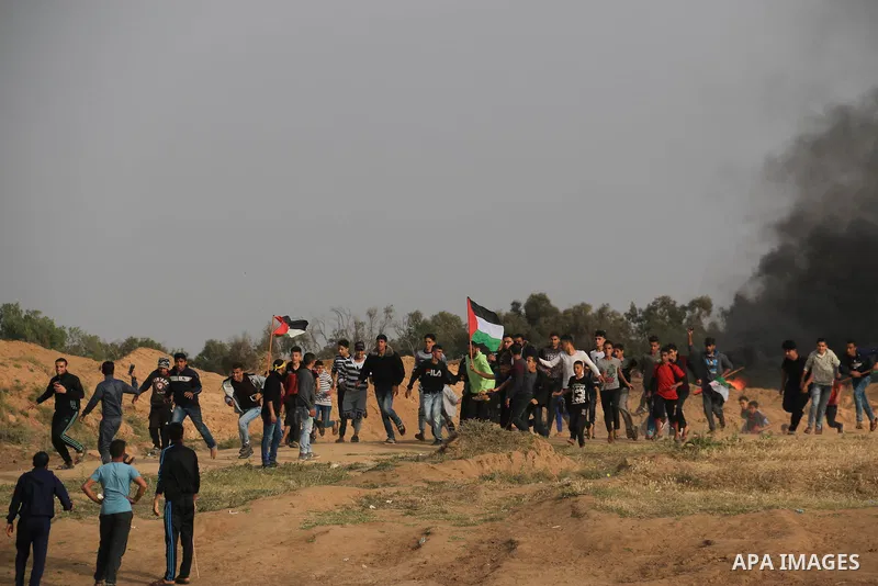 Palestinian protesters clash with Israeli security forces in a tent city protest at along the Israel border with Gaza, demanding the right to return to their homeland, in al-Bureij in the center of Gaza strip, on April 0...