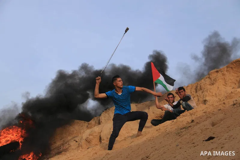 Palestinian protesters clash with Israeli security forces in a tent city protest at along the Israel border with Gaza, demanding the right to return to their homeland, in al-Bureij in the center of Gaza strip, on April 0...