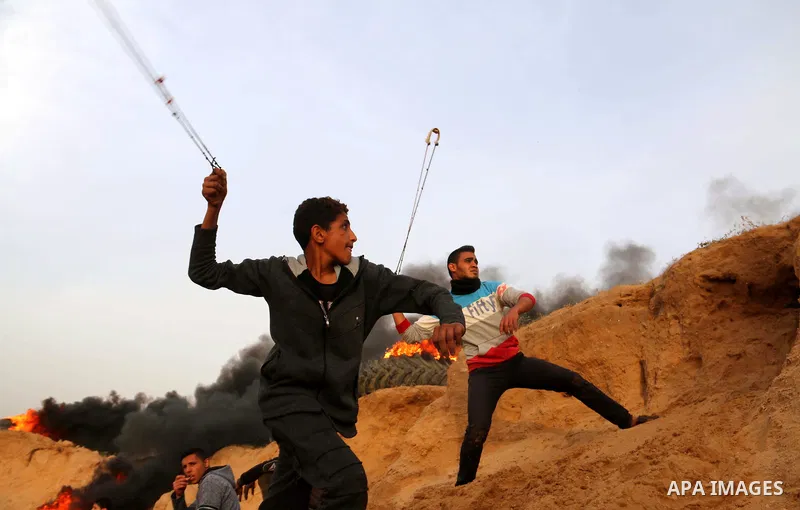Palestinian protesters clash with Israeli security forces in a tent city protest at along the Israel border with Gaza, demanding the right to return to their homeland, in al-Bureij in the center of Gaza strip, on April 0...