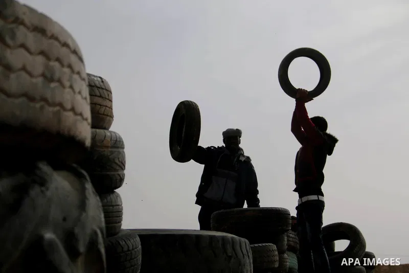 Palestinian protesters bring old tires with pickup trucks as they take part in a demonstration demanding the right of return and removal of the blockade following the "Great March of Return" in Bureij, Gaza on April 05,...