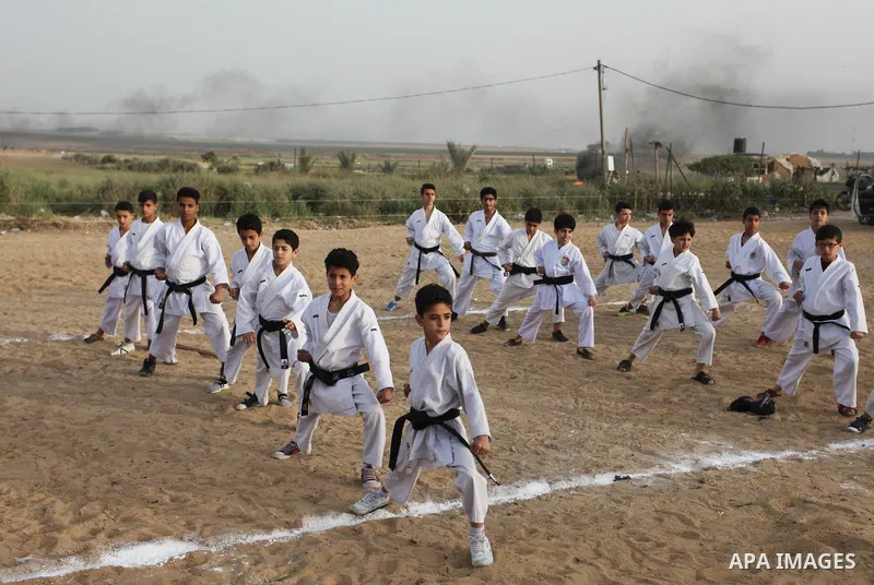 Palestinian children play Karate near to the site of clashes between Palestinian demonstrators and Israeli security forces following a protest along the Gaza-Israel border, east of Gaza City on April 5, 2018. Palestinian...