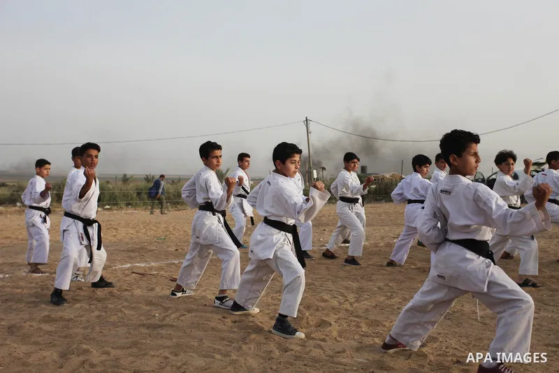 Palestinian children play Karate near to the site of clashes between Palestinian demonstrators and Israeli security forces following a protest along the Gaza-Israel border, east of Gaza City on April 5, 2018. Palestinian...