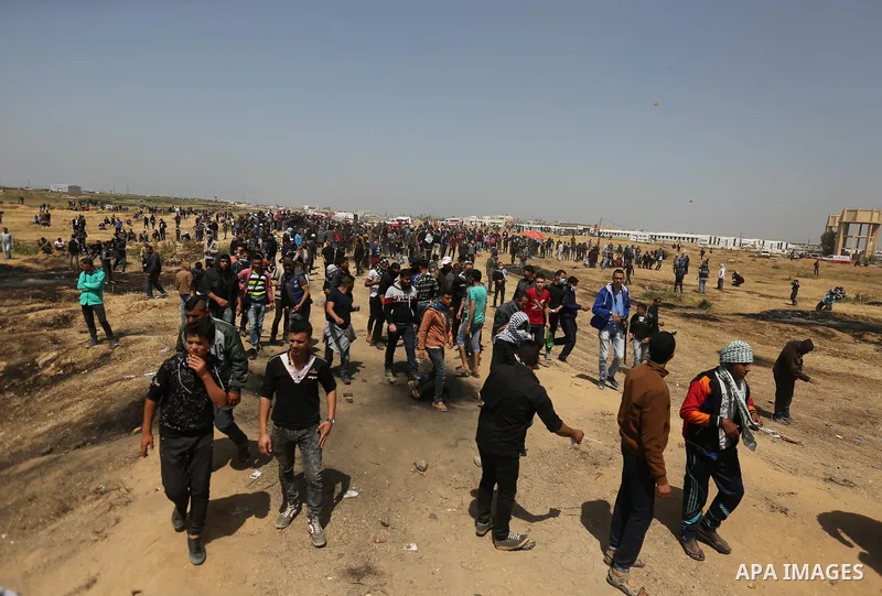 Palestinian protesters take part during clashes with Israeli security forces at the Israel-Gaza border in a tent city protest demanding the right to return to their homeland, in east of Gaza city on April 6, 2018. Photo...