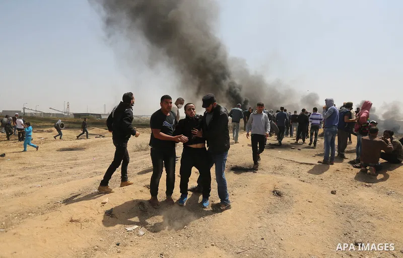 A wounded Palestinian protester is evacuated during clashes with Israeli security forces at the Israel-Gaza border in a tent city protest demanding the right to return to their homeland, in east of Gaza city on April 6,...