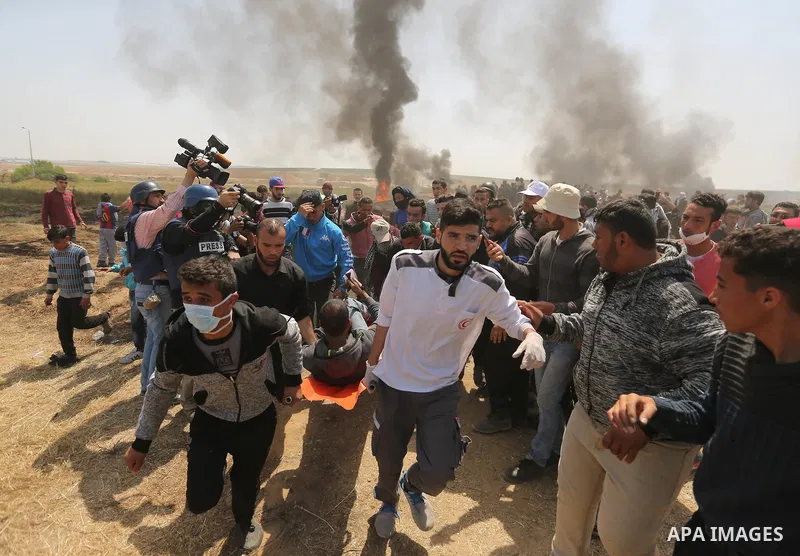 A wounded Palestinian protester is evacuated during clashes with Israeli security forces at the Israel-Gaza border in a tent city protest demanding the right to return to their homeland, in east of Gaza city on April 6,...