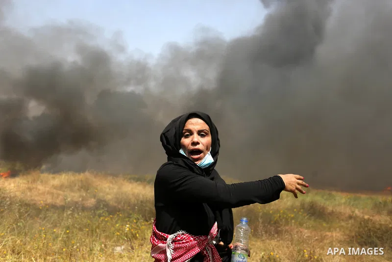 Palestinian protesters burn tires to protect themselves from shots of Israeli soldiers during clashes in a tent city protest at the Israel-Gaza border, demanding the right to return to their homeland, in Khan Younis in t...