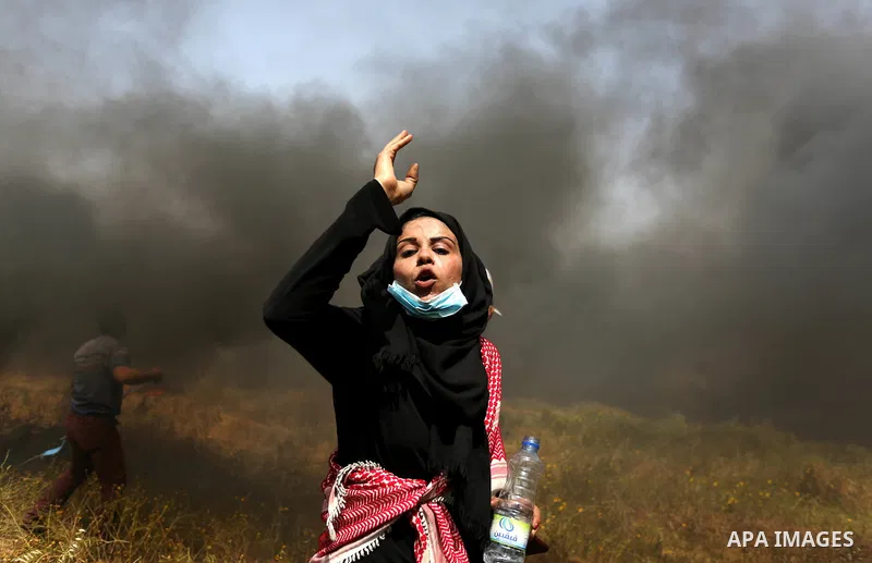 Palestinian protesters burn tires to protect themselves from shots of Israeli soldiers during clashes in a tent city protest at the Israel-Gaza border, demanding the right to return to their homeland, in Khan Younis in t...