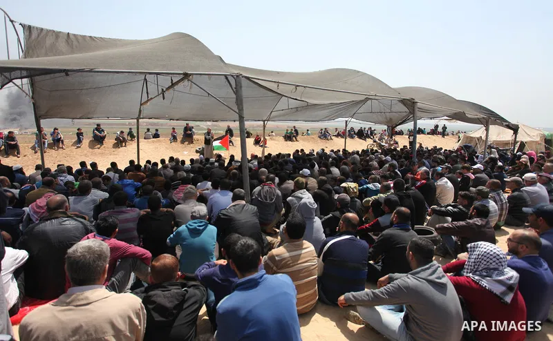 Palestinian Muslim worshippers perform Friday noon prayers during a tent city protest along the Israel border with Gaza, demanding the right to return to their homeland, in Jabalia in the northern of Gaza strip on April...