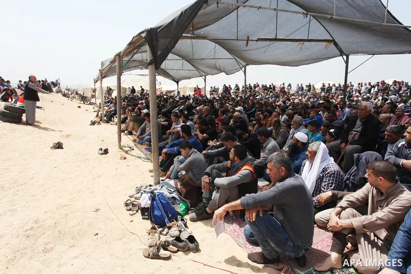 Palestinian Muslim worshippers perform Friday noon prayers during a tent city protest along the Israel border with Gaza, demanding the right to return to their homeland, in Jabalia in the northern of Gaza strip on April...
