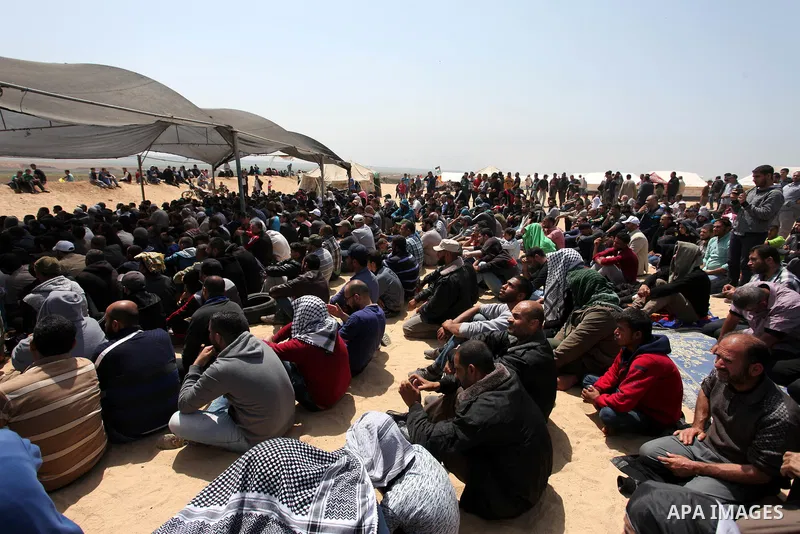 Palestinian Muslim worshippers perform Friday noon prayers during a tent city protest along the Israel border with Gaza, demanding the right to return to their homeland, in Jabalia in the northern of Gaza strip on April...