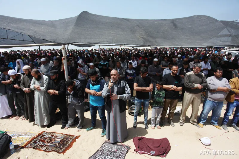 Palestinian Muslim worshippers perform Friday noon prayers during a tent city protest along the Israel border with Gaza, demanding the right to return to their homeland, in Jabalia in the northern of Gaza strip on April...
