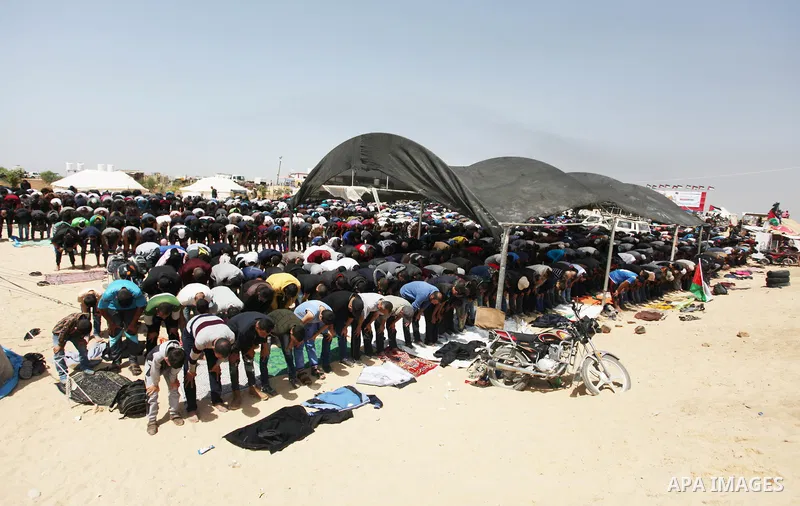 Palestinian Muslim worshippers perform Friday noon prayers during a tent city protest along the Israel border with Gaza, demanding the right to return to their homeland, in Jabalia in the northern of Gaza strip on April...