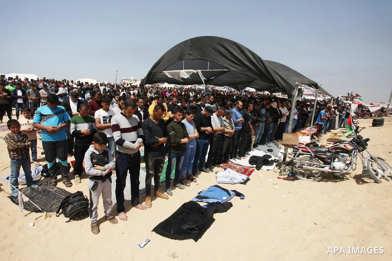 Palestinian Muslim worshippers perform Friday noon prayers during a tent city protest along the Israel border with Gaza, demanding the right to return to their homeland, in Jabalia in the northern of Gaza strip on April...