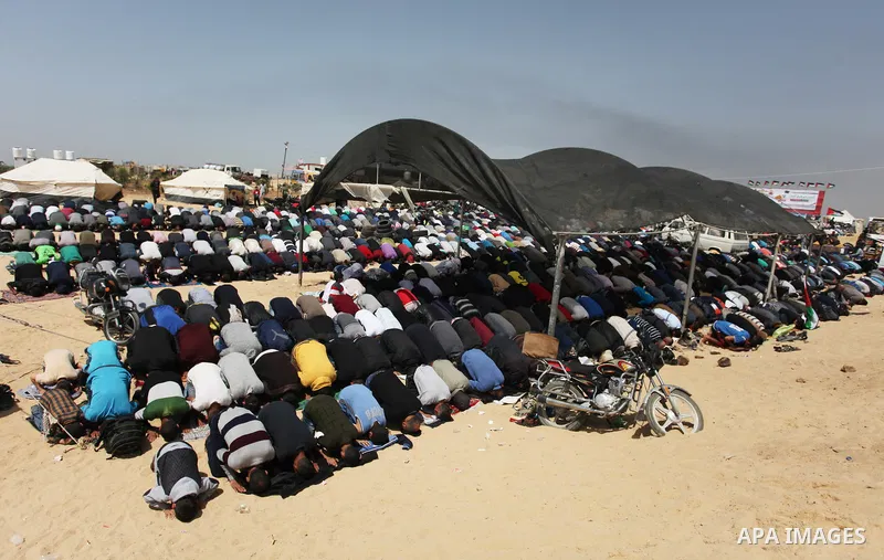Palestinian Muslim worshippers perform Friday noon prayers during a tent city protest along the Israel border with Gaza, demanding the right to return to their homeland, in Jabalia in the northern of Gaza strip on April...