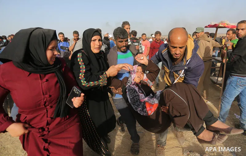 A wounded Palestinian protester is evacuated during clashes with Israeli security forces at the Israel-Gaza border in a tent city protest demanding the right to return to their homeland, in Khan Younis in the southern Ga...