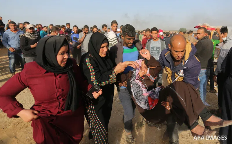 A wounded Palestinian protester is evacuated during clashes with Israeli security forces at the Israel-Gaza border in a tent city protest demanding the right to return to their homeland, in Khan Younis in the southern Ga...