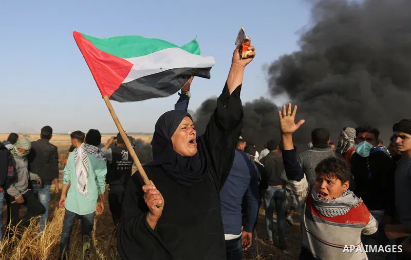Palestinian protesters burn tires to protect themselves from shots of Israeli soldiers during clashes in a tent city protest at the Israel-Gaza border, demanding the right to return to their homeland, in Khan Younis in t...