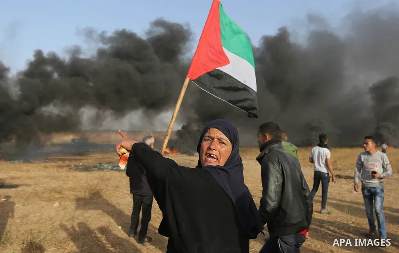 Palestinian protesters burn tires to protect themselves from shots of Israeli soldiers during clashes in a tent city protest at the Israel-Gaza border, demanding the right to return to their homeland, in Khan Younis in t...