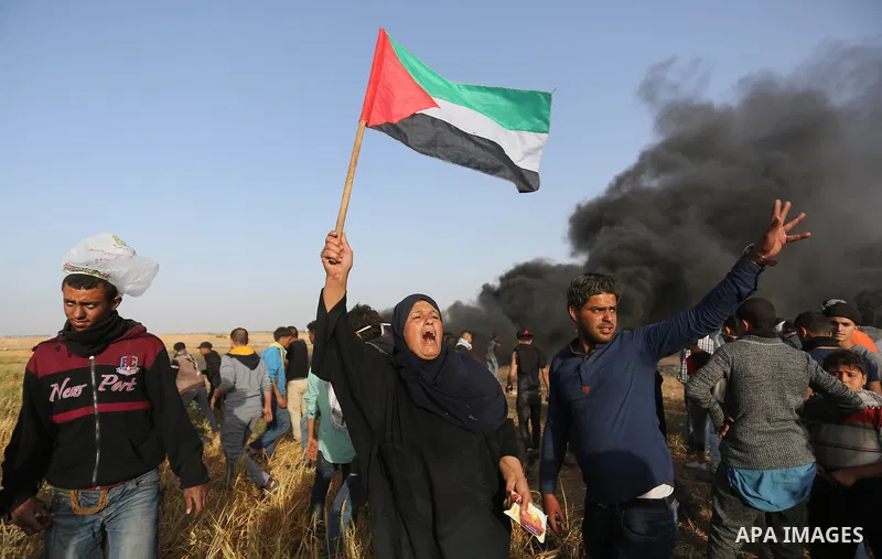 Palestinian protesters burn tires to protect themselves from shots of Israeli soldiers during clashes in a tent city protest at the Israel-Gaza border, demanding the right to return to their homeland, in Khan Younis in t...