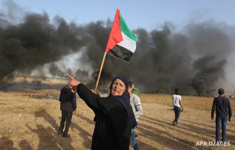 Palestinian protesters burn tires to protect themselves from shots of Israeli soldiers during clashes in a tent city protest at the Israel-Gaza border, demanding the right to return to their homeland, in Khan Younis in t...
