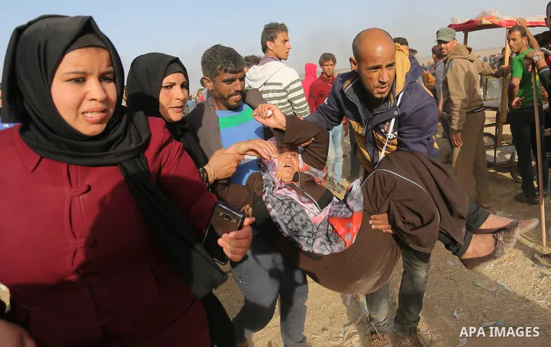 A wounded Palestinian protester is evacuated during clashes with Israeli security forces at the Israel-Gaza border in a tent city protest demanding the right to return to their homeland, in Khan Younis in the southern Ga...