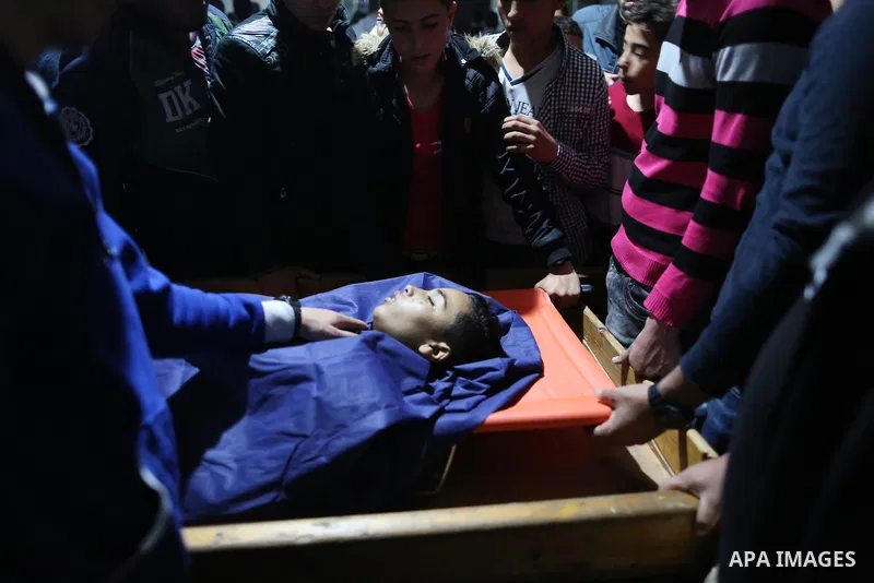 Palestinians mourn over the body of Hussein Madi, 14, who was killed by Israeli security forces during clashes along Israel border with Gaza, in Gaza city on April 6, 2018. Photo by Ramadan Elagha
