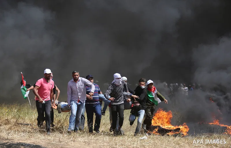 A wounded Palestinian protester is evacuated during clashes with Israeli security forces at the Israel-Gaza border in a tent city protest demanding the right to return to their homeland, in Khan Younis in the southern Ga...