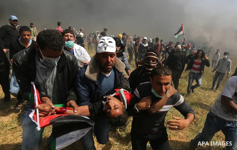 A wounded Palestinian protester is evacuated during clashes with Israeli security forces at the Israel-Gaza border in a tent city protest demanding the right to return to their homeland, in Khan Younis in the southern Ga...