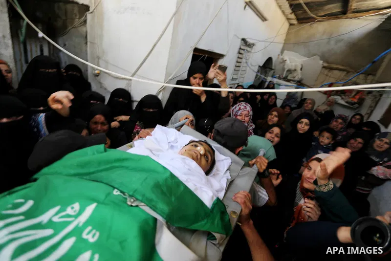 Palestinian mourners carry the body of Alaa al-Zamili, 15, who who died the day before during clashes with Isareli security forces at the Israel-Gaza border, during his funeral in Rafah in the southern Gaza strip on Apri...