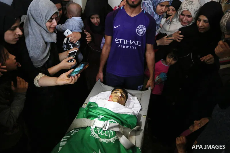 Relatives mourn over the body of Alaa al-Zamili, 15, who who died the day before during clashes with Isareli security forces at the Israel-Gaza border, during his funeral in Rafah in the southern Gaza strip on April 7, 2...