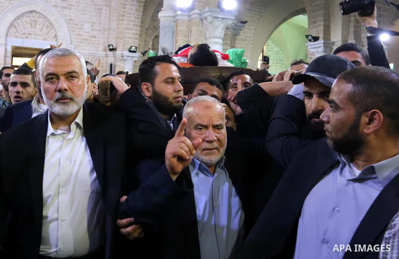 Hamas Chief Ismail Haniyeh carries the body of Palestinian journalist Yasser Murtaja, 30, who died from his injuries after he was shot by Israeli security forces during clashes at the Israel-Gaza border on Friday, during...