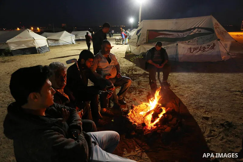 Palestinians sit next to tents during a tent city protest east of Gaza City April 9, 2018. Photo by Ashraf Amra