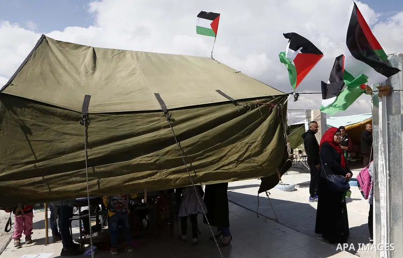 Palestinians gather at the site of their school after Israeli forces it was demolished by Israeli security forces who claim it was built on illegal land, in the West Bank city of Hebron on April 10, 2018. Photo by Wisam...