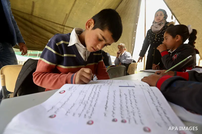 Palestinian schoolchildren attend a class in a tent at the site of their school after it was demolished by Israeli security forces who claim it was built on illegal land, in the West Bank city of Hebron on April 10, 2018...
