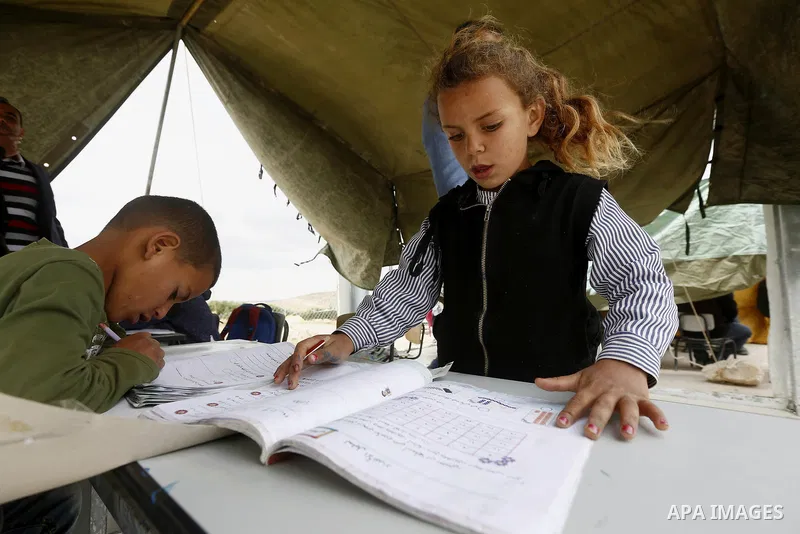 Palestinian schoolchildren attend a class in a tent at the site of their school after it was demolished by Israeli security forces who claim it was built on illegal land, in the West Bank city of Hebron on April 10, 2018...