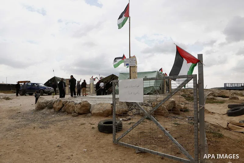 Palestinians gather at the site of their school after Israeli forces it was demolished by Israeli security forces who claim it was built on illegal land, in the West Bank city of Hebron on April 10, 2018. Photo by Wisam...