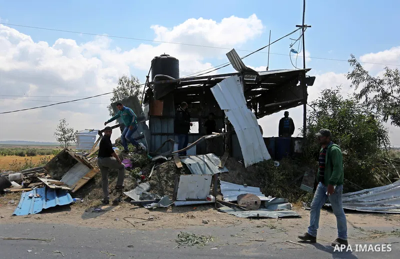 Palestinians inspect the site targeted by Israeli tank fire on the outskirts of Gaza City, near the border with Israel, on April 11, 2018. Israeli tanks shelled sites in eastern Gaza City on Wednesday morning, in what th...