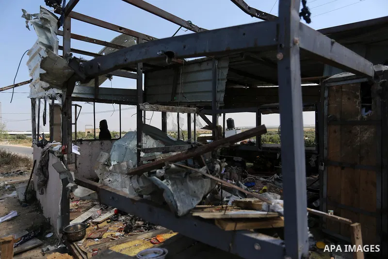 Palestinians inspect the site targeted by Israeli tank fire on the outskirts of Gaza City, near the border with Israel, on April 11, 2018. Israeli tanks shelled sites in eastern Gaza City on Wednesday morning, in what th...